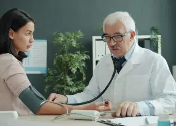 Doctor checking a patient's blood pressure during an annual medical visit